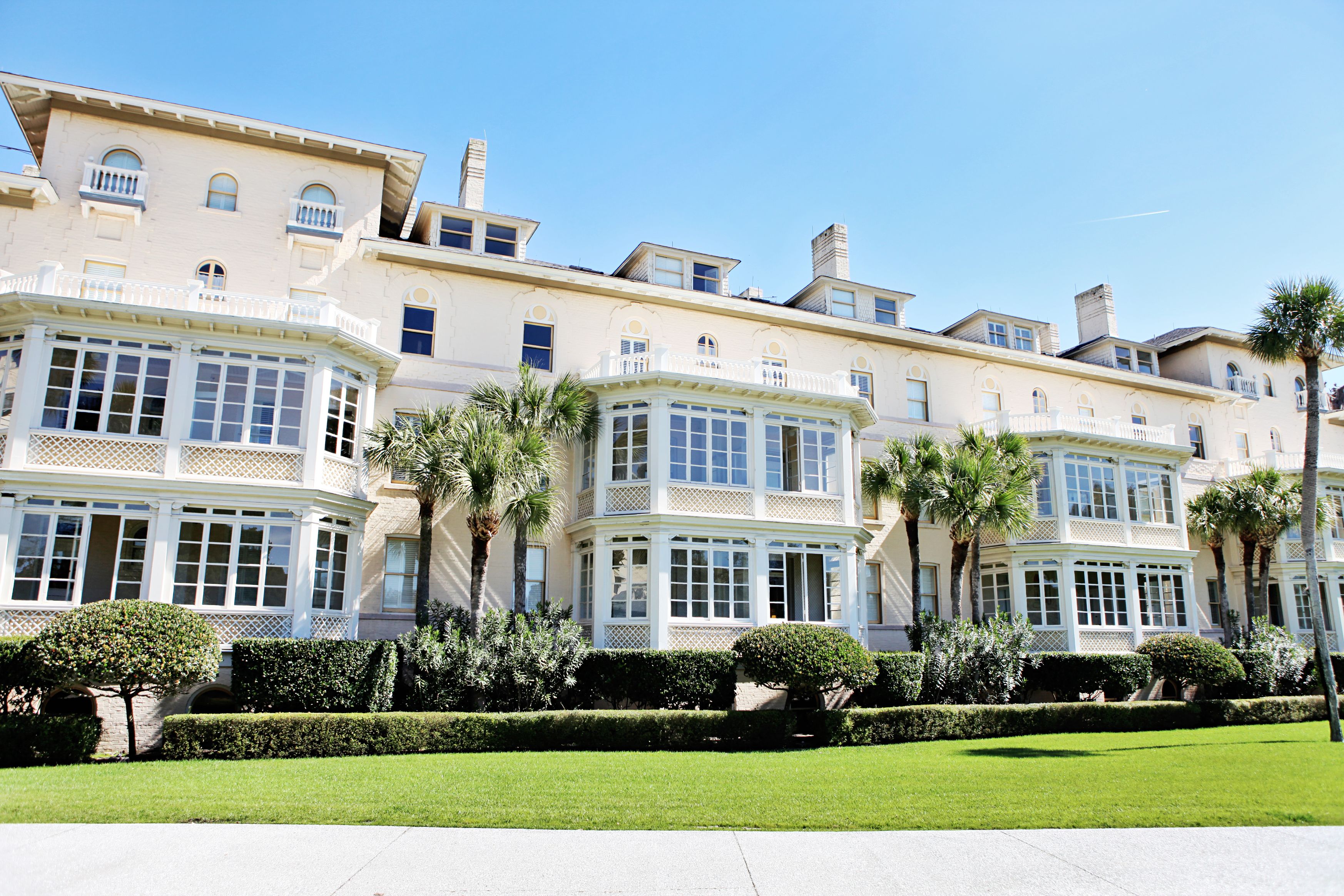 a large building with many windows and a lawn