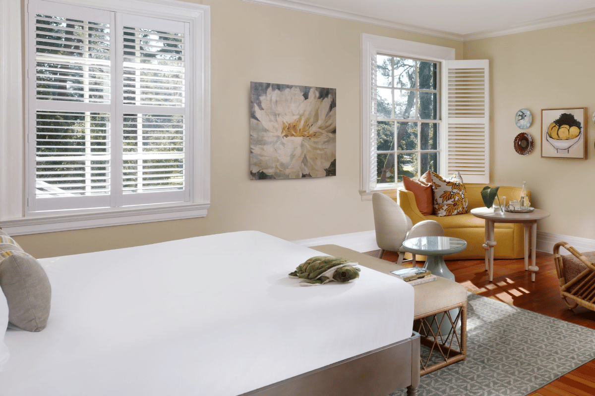 a room with a bed and a couch and a painting on the wall