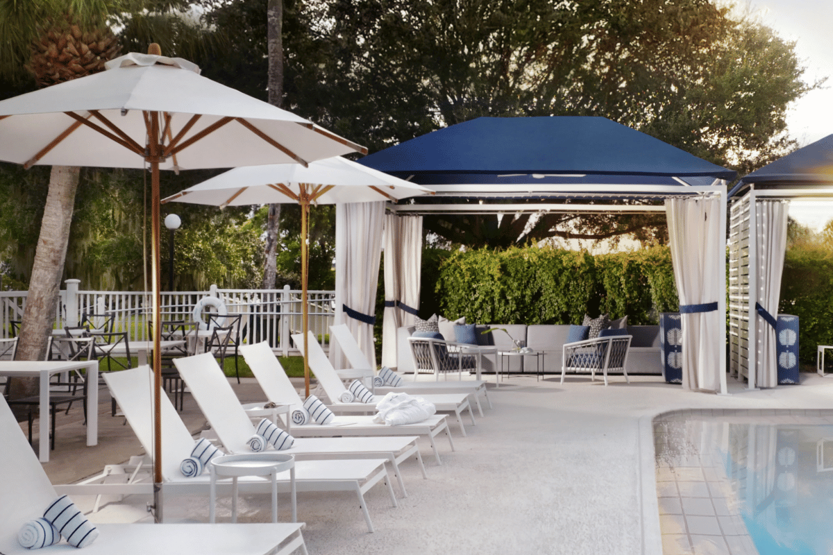 a pool with chairs and umbrellas
