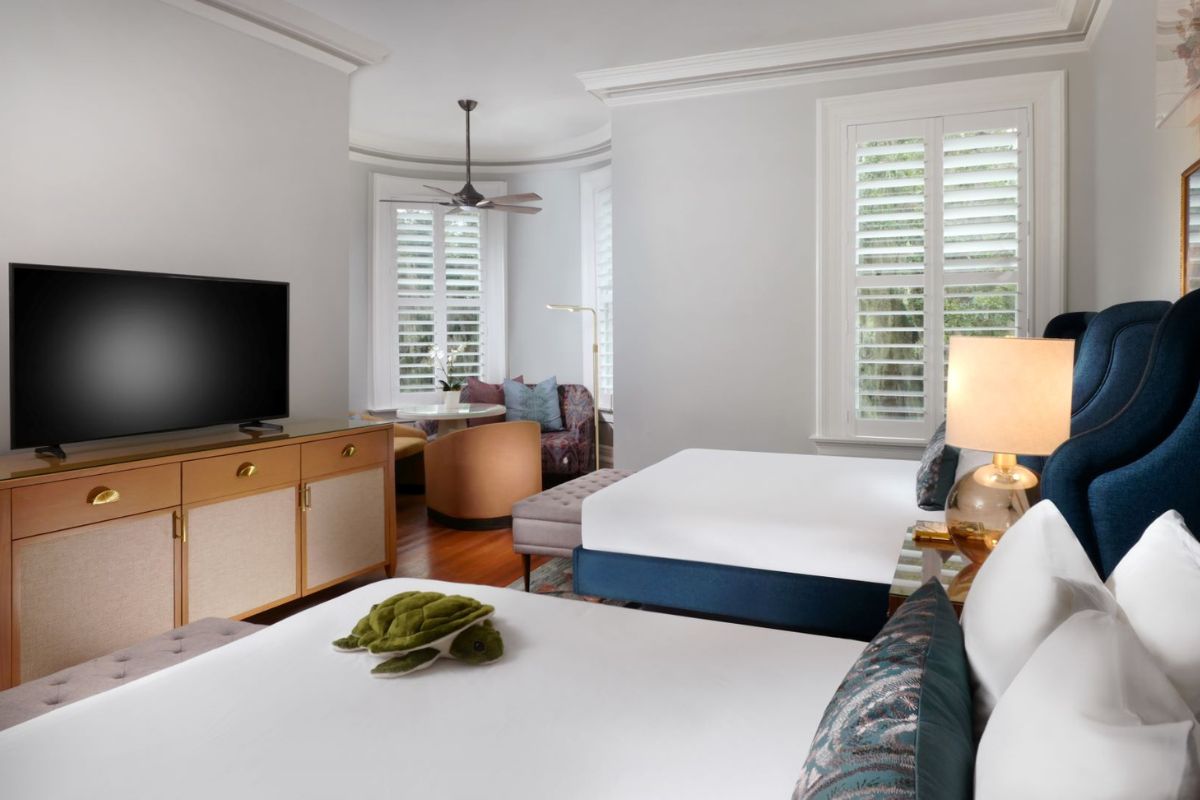 a room with two beds and a television