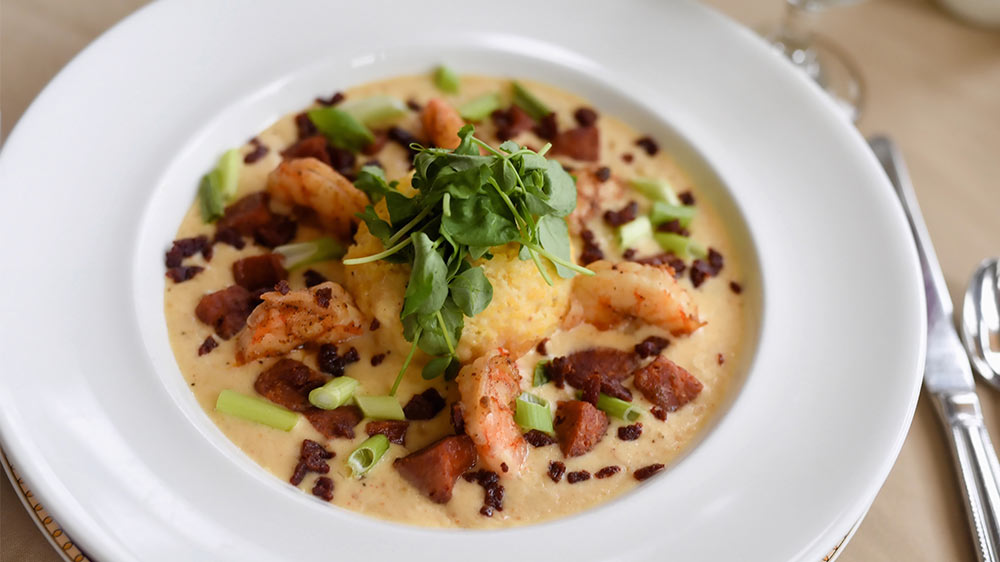 a bowl of food with shrimp and vegetables