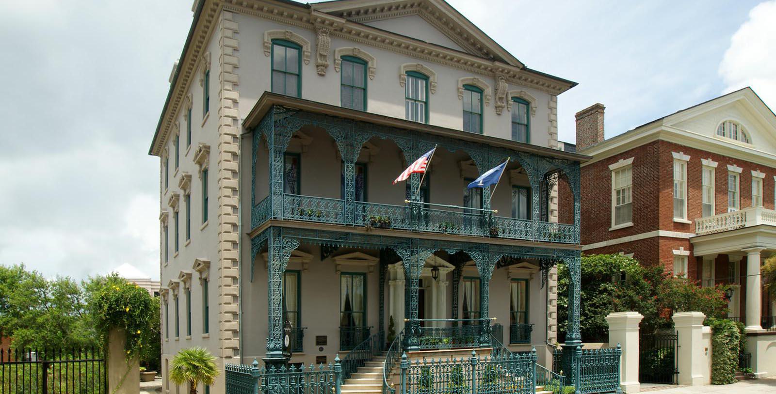 a building with a balcony and flags