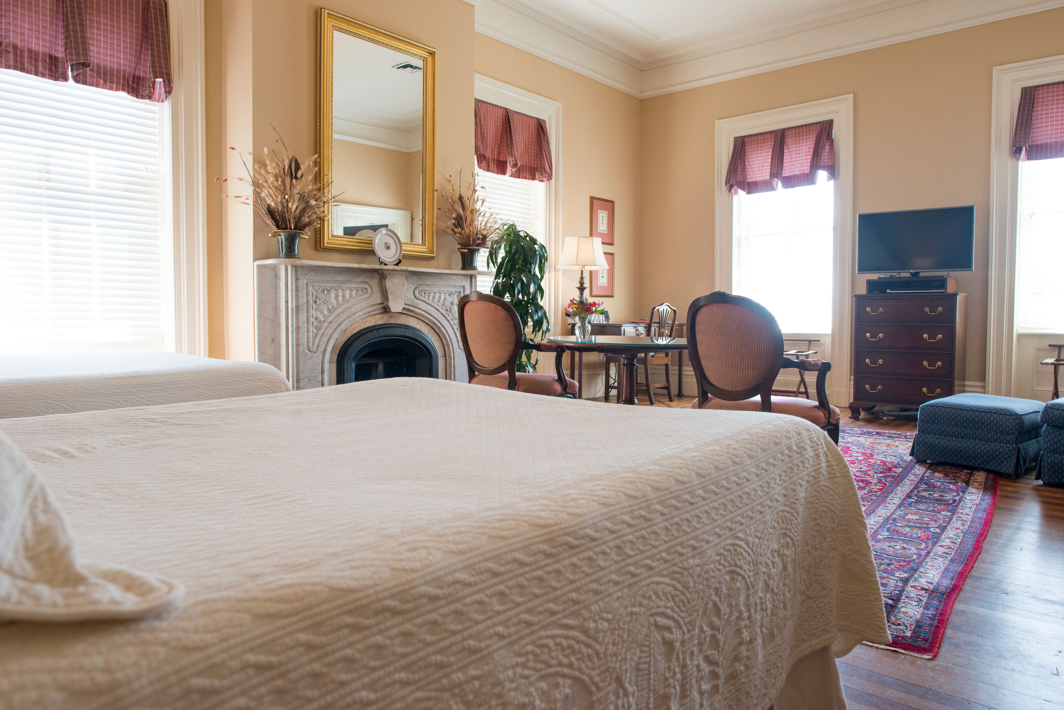 a bedroom with a fireplace and a bed