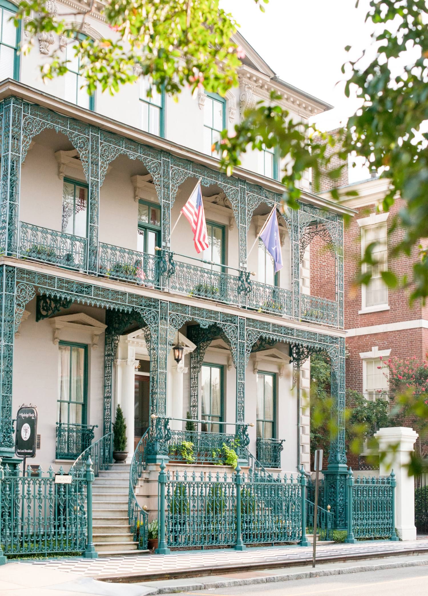 a building with a fence and flags