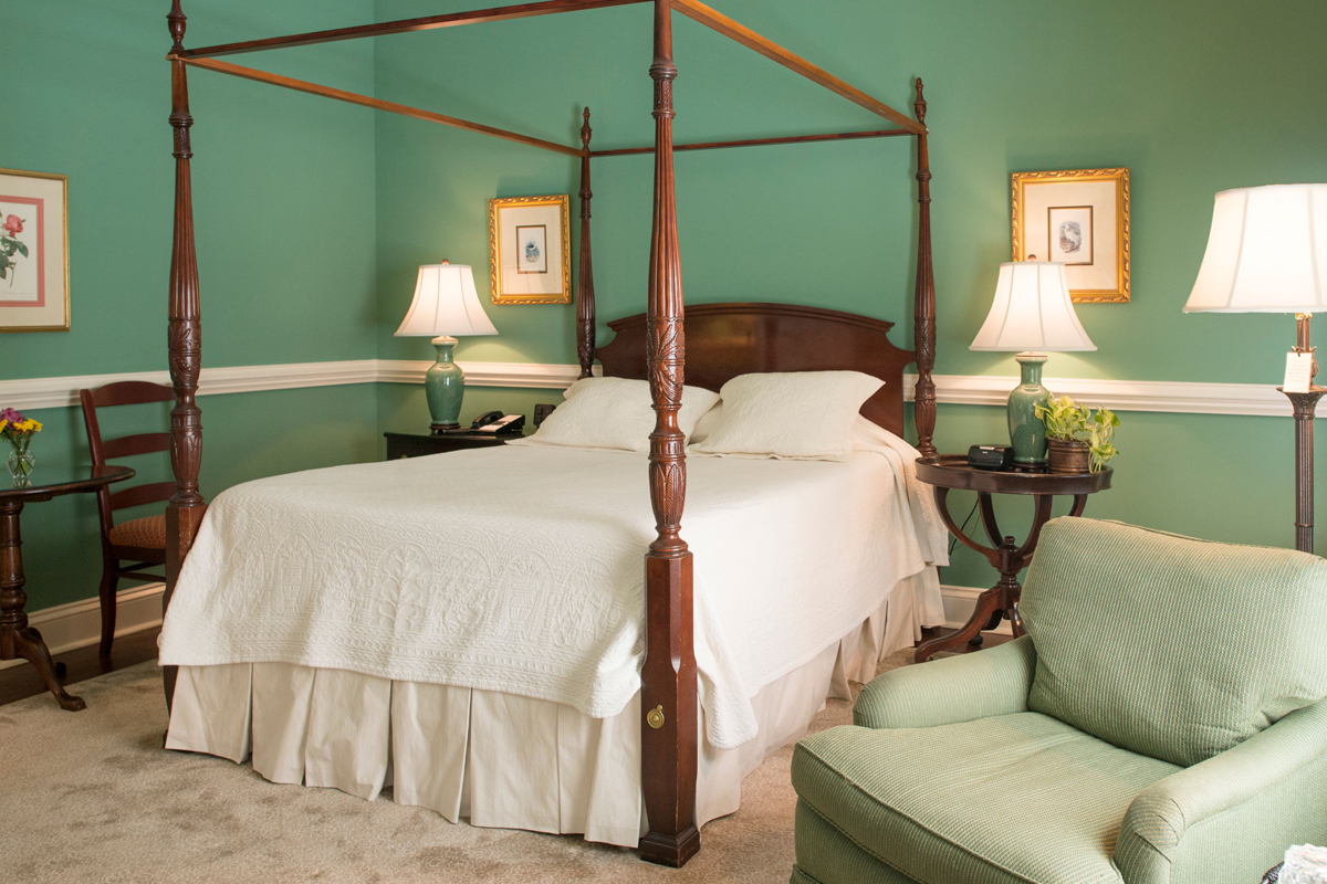 a bed with a four poster bed