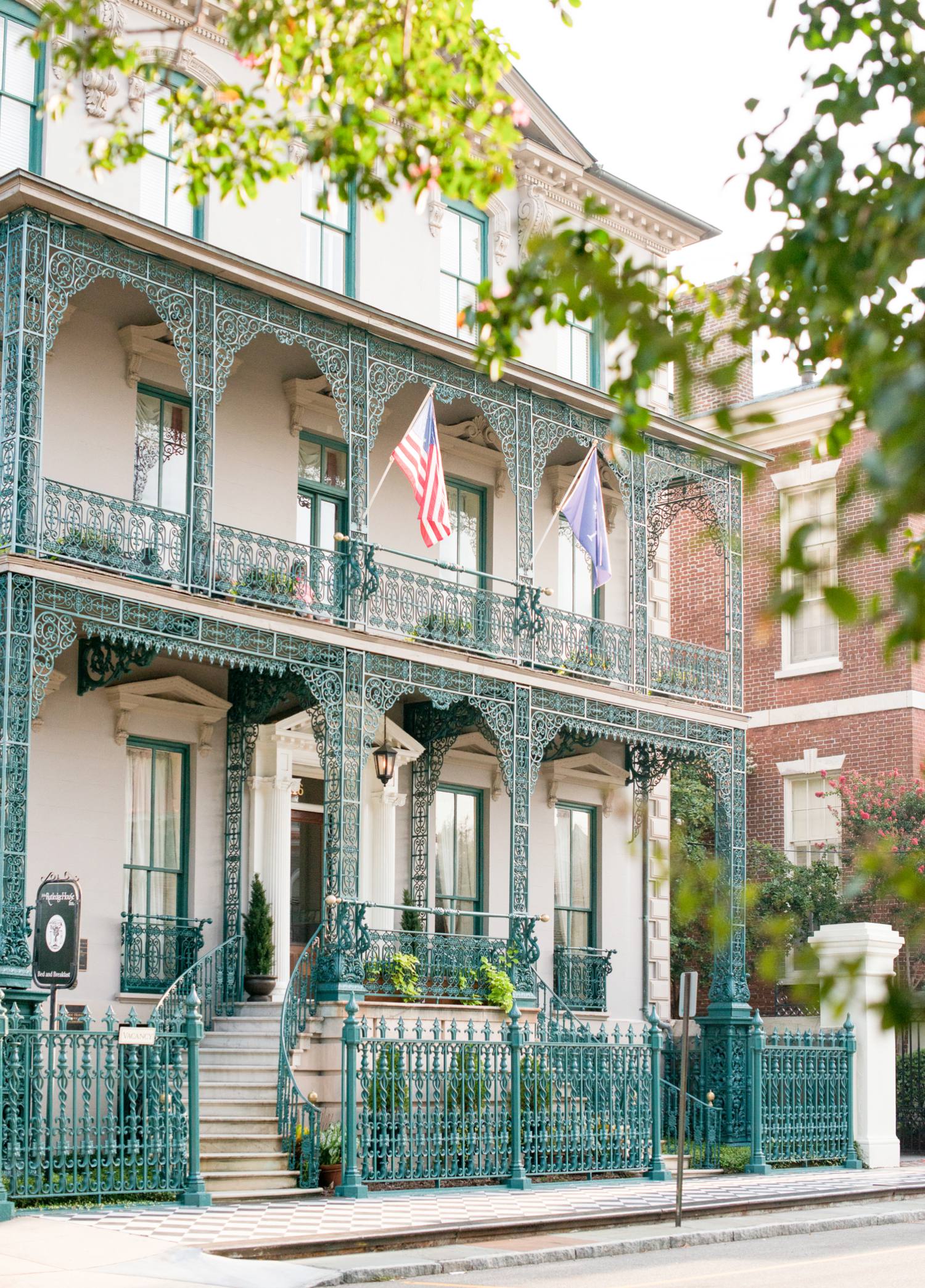 a building with a fence and flags