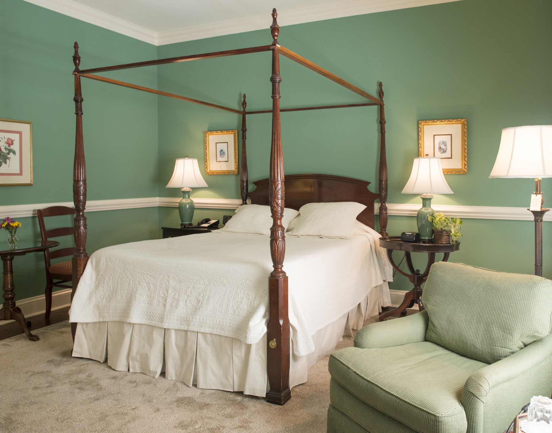 a bedroom with a four poster bed and a chair