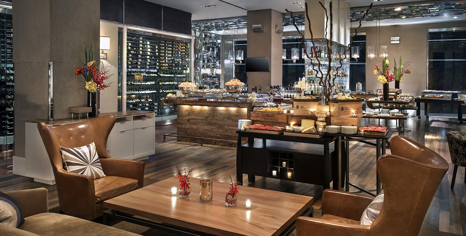 a room with a buffet table and wine bottles
