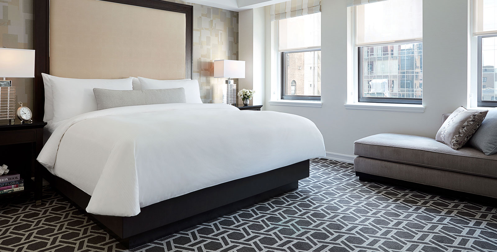 a bedroom with a bed and a stool