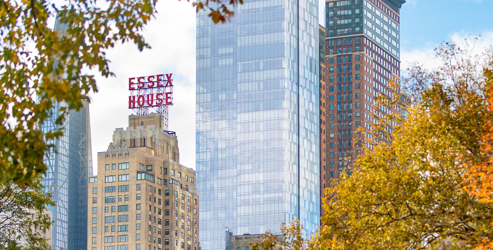 a tall glass building with a sign on top of it