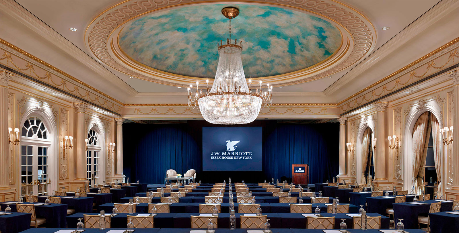 a room with a chandelier and tables