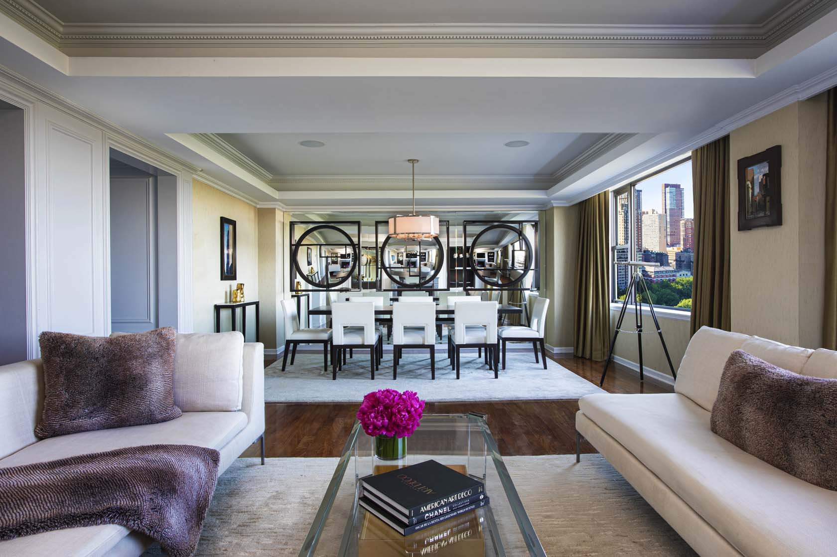a living room with a dining table and chairs