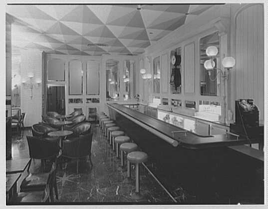 a bar with stools and a counter