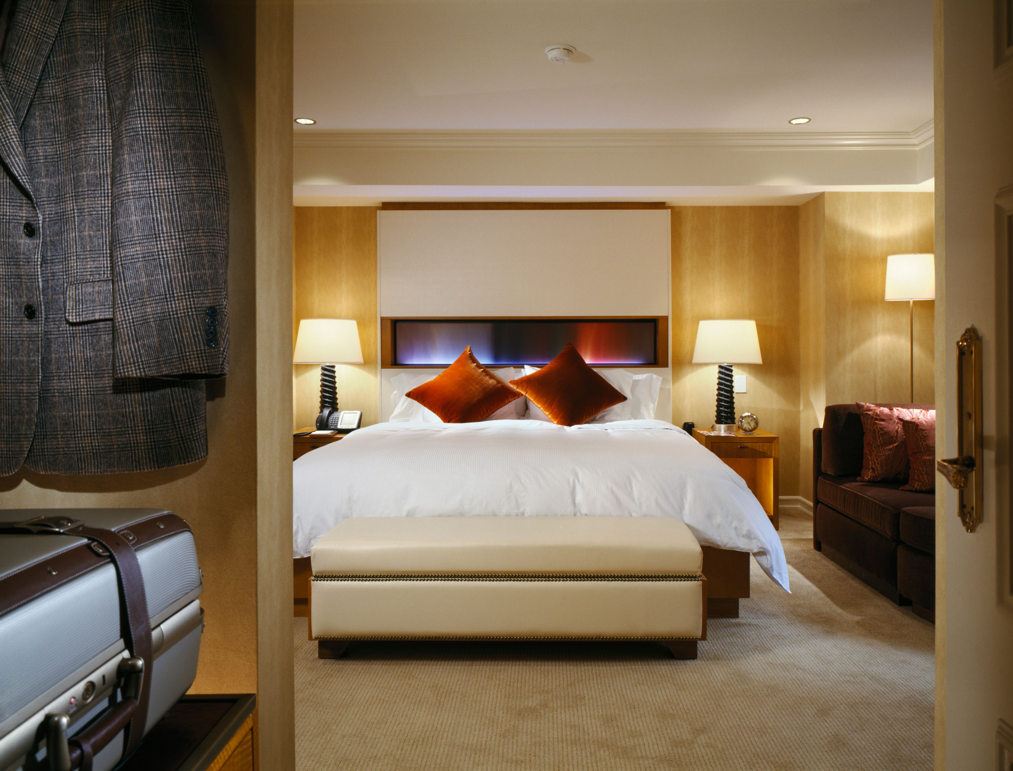 a bedroom with a bed and two chairs