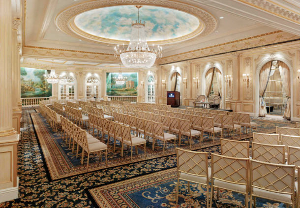 a room with chairs and chandeliers