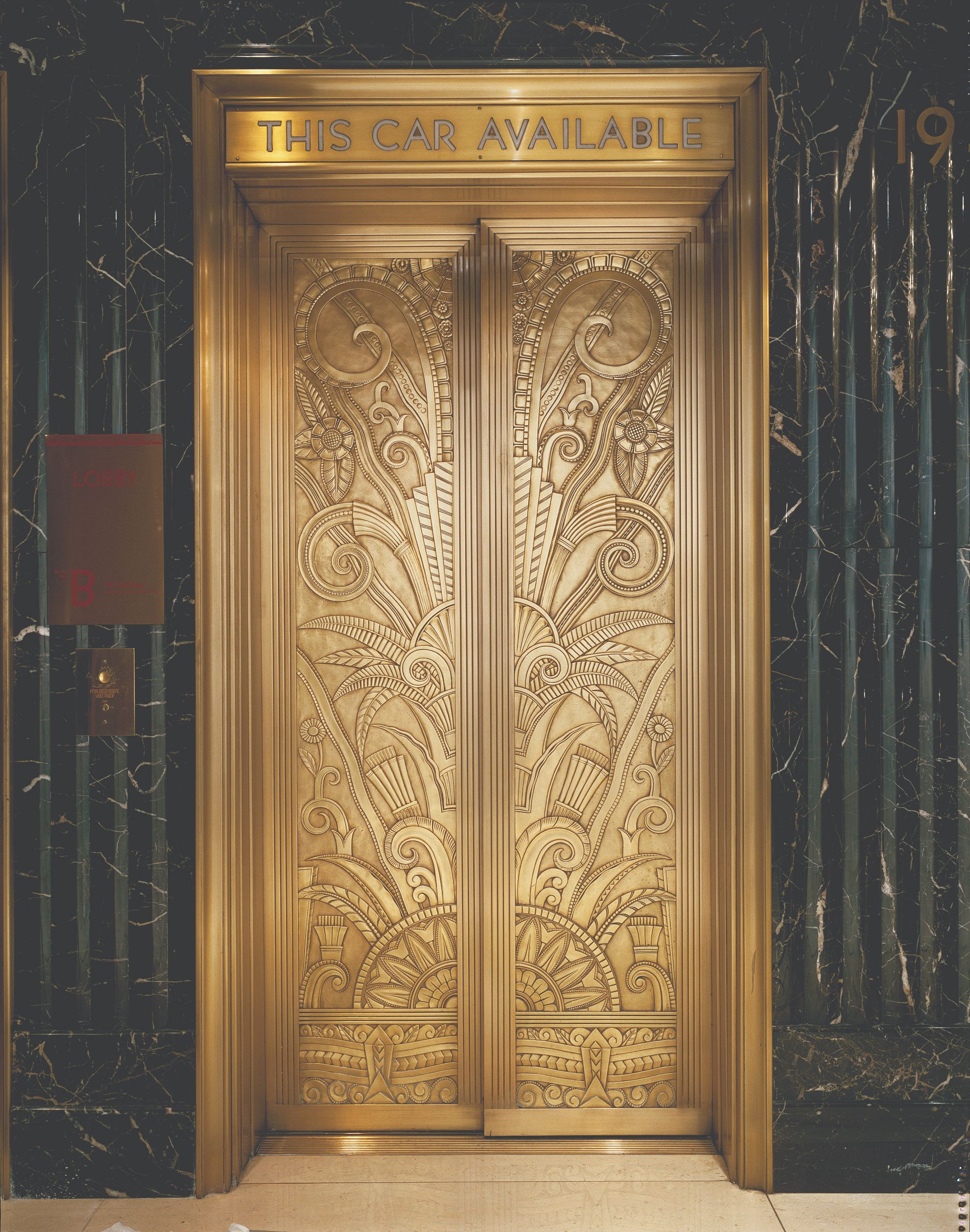 a gold door with a floral design