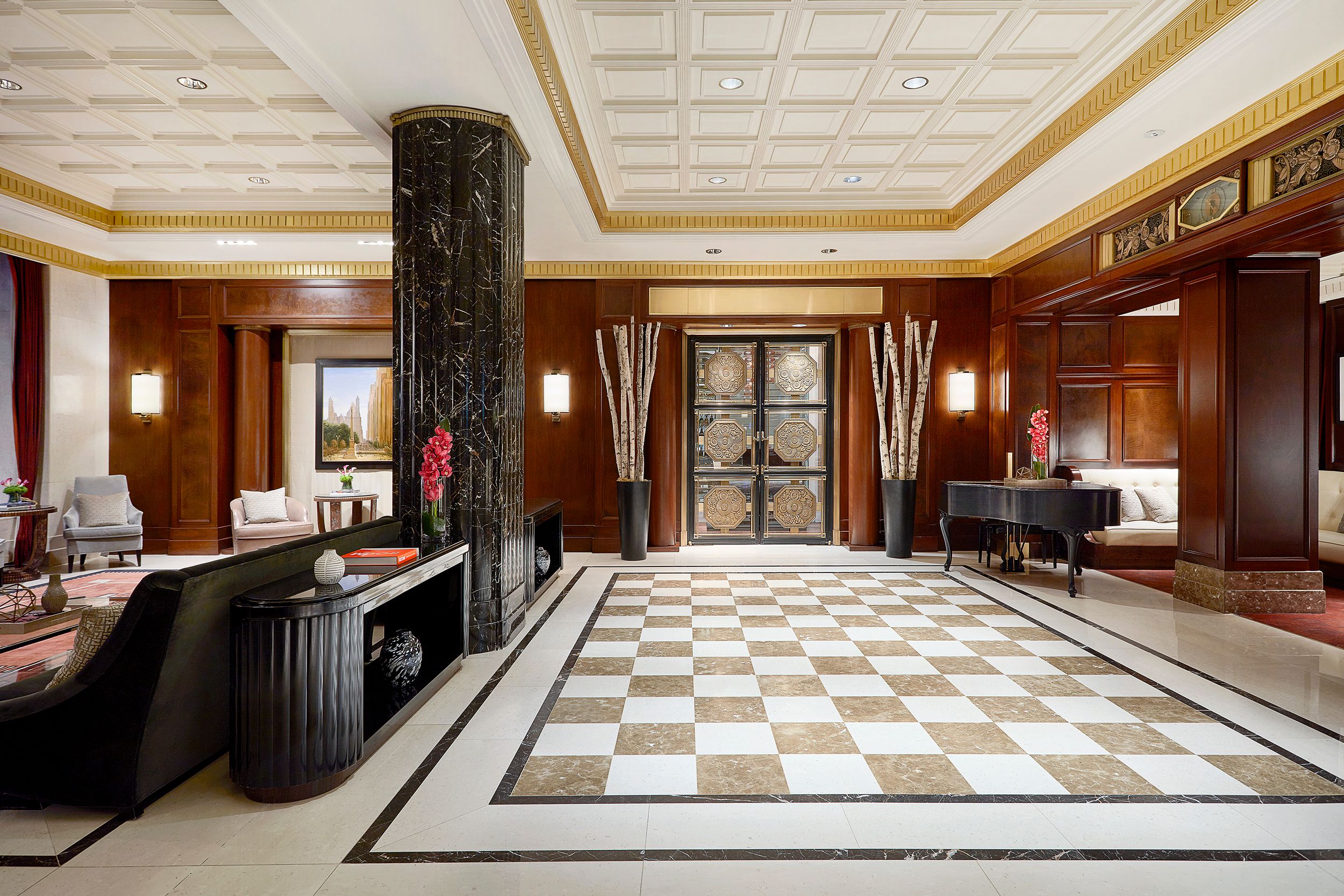 a large hall with a piano and a checkered floor