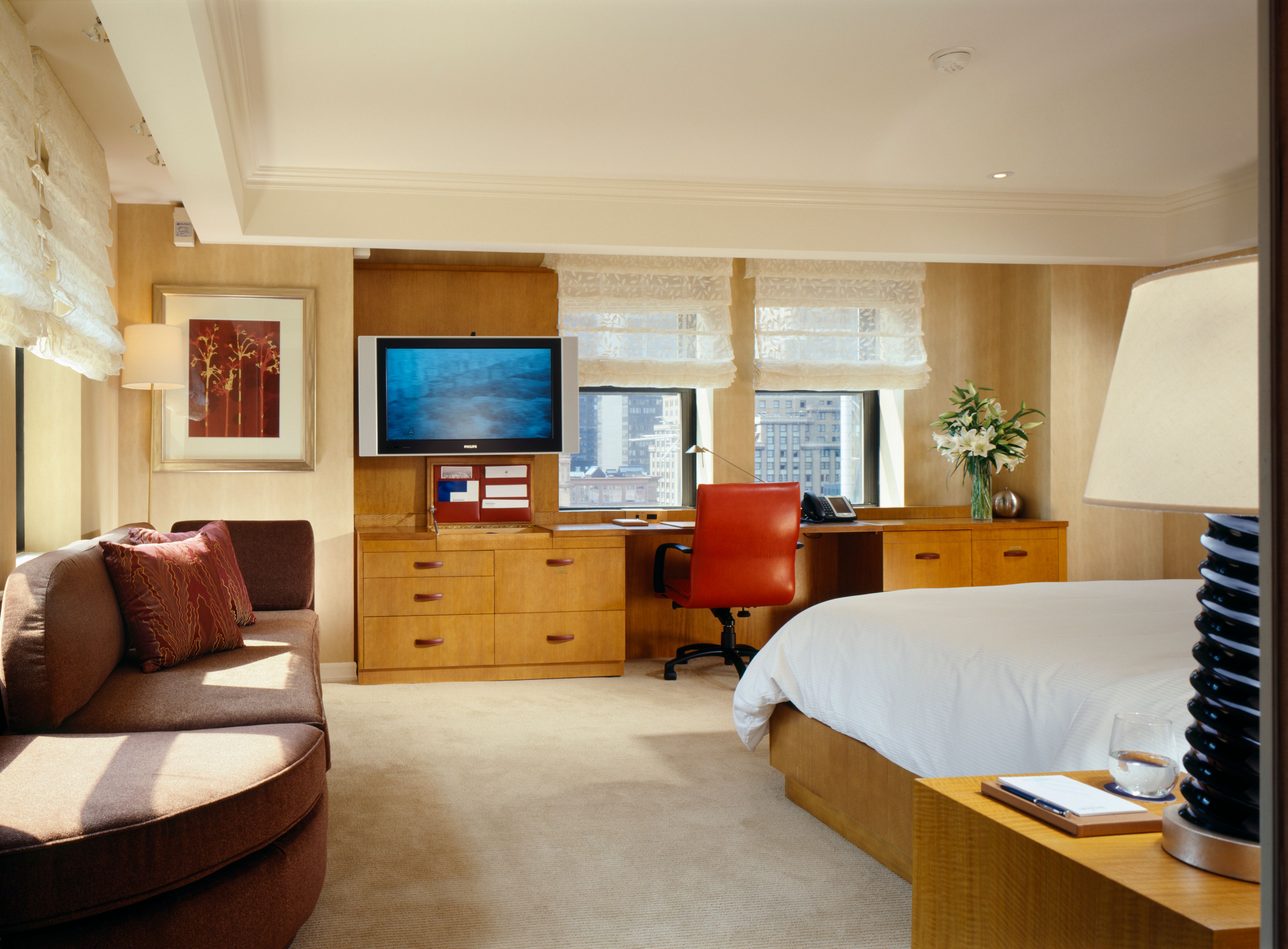 a bedroom with a bed and a tv