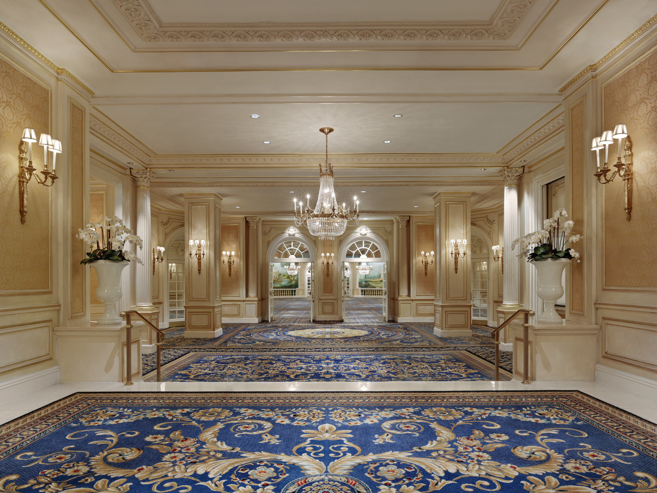 a large room with blue carpet and chandeliers