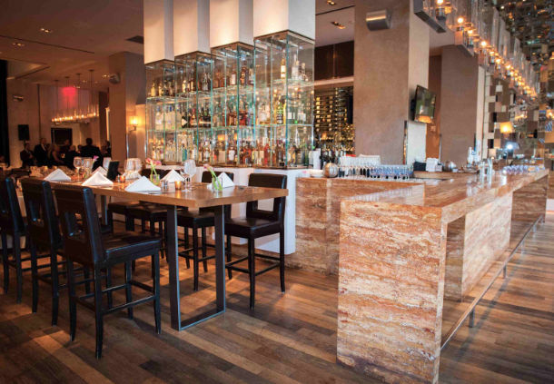 a bar with a counter and a shelf of liquor