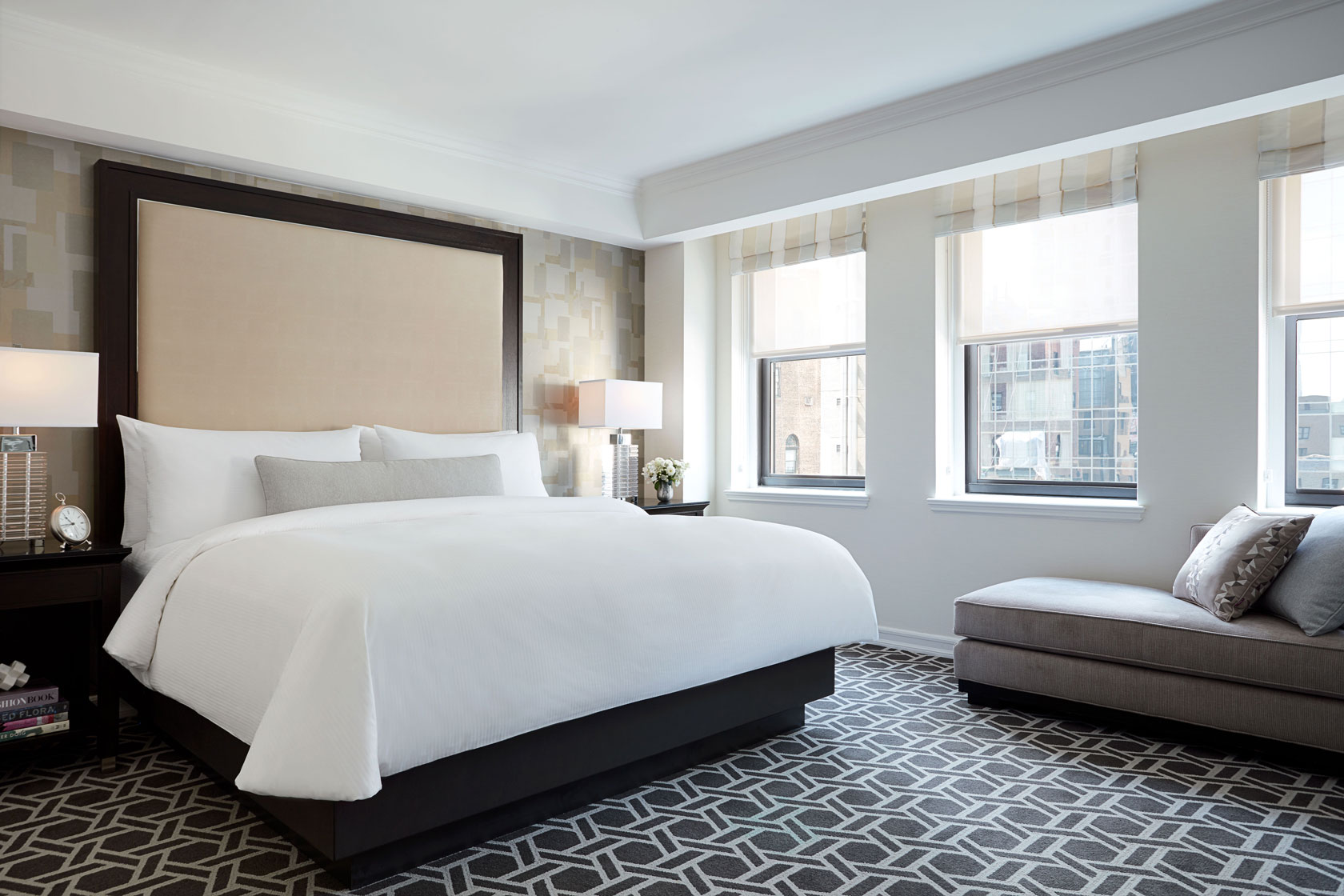 a bedroom with a bed and a stool