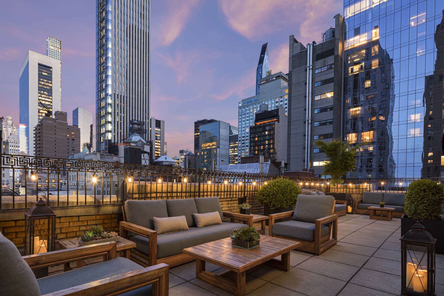 a rooftop patio with a city skyline in the background