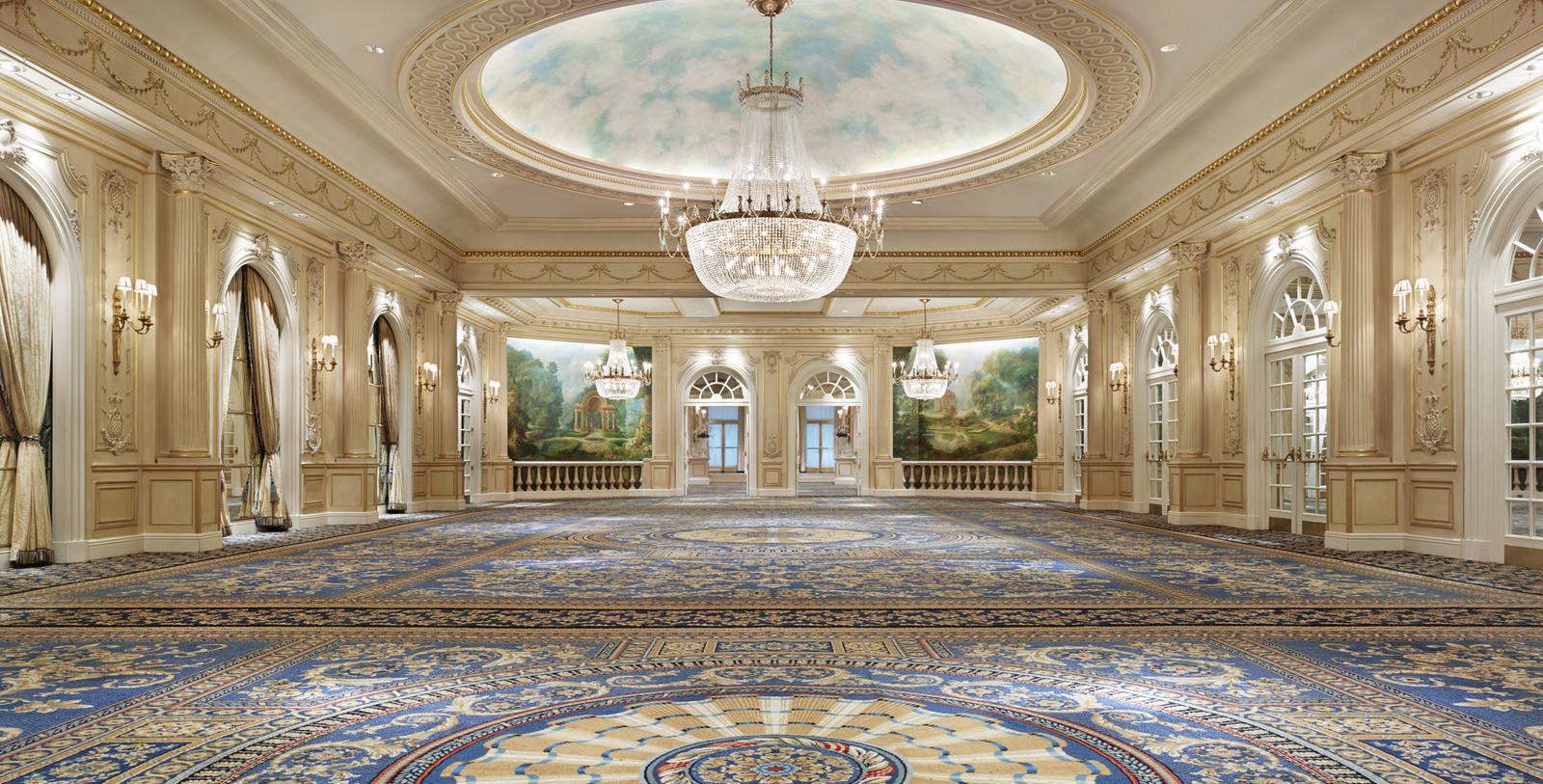 a large room with a chandelier and a large carpet