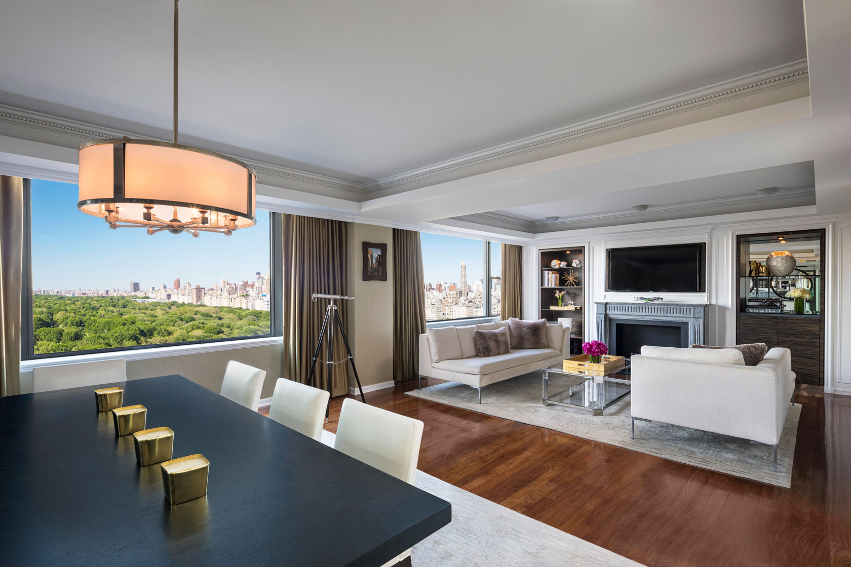a living room with a large window overlooking a city