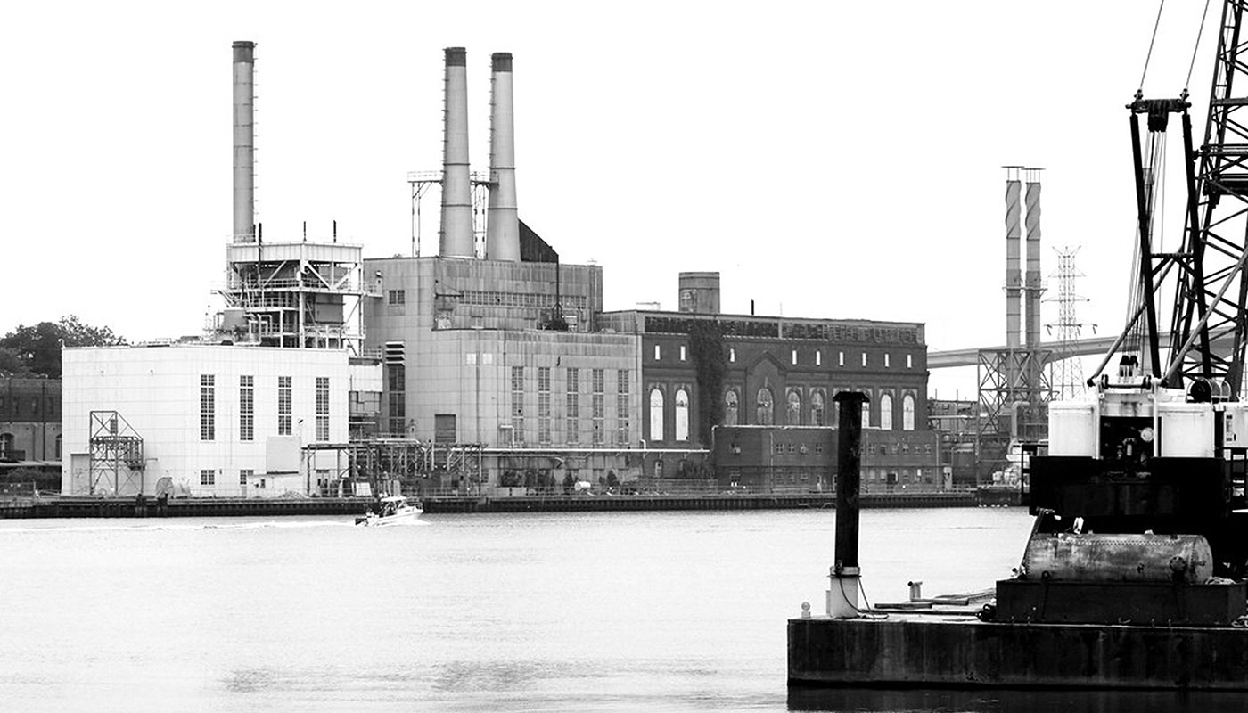 a factory next to a body of water