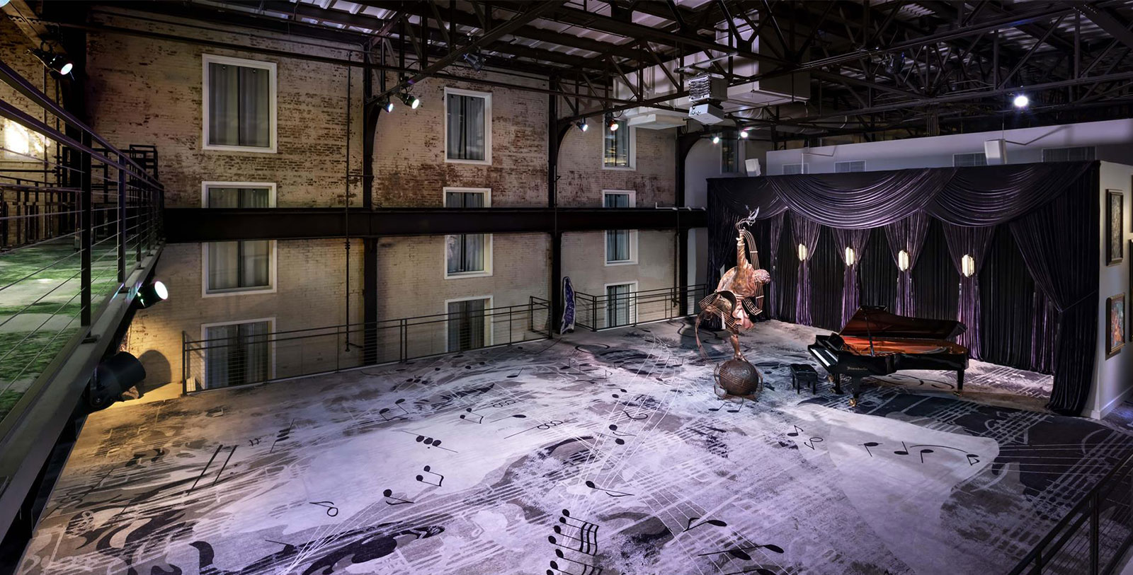 a stage with a piano and a statue on it