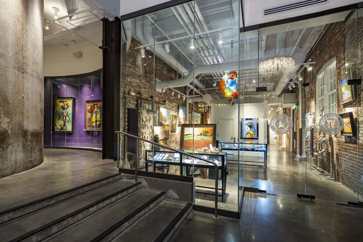 a glass wall with art on display