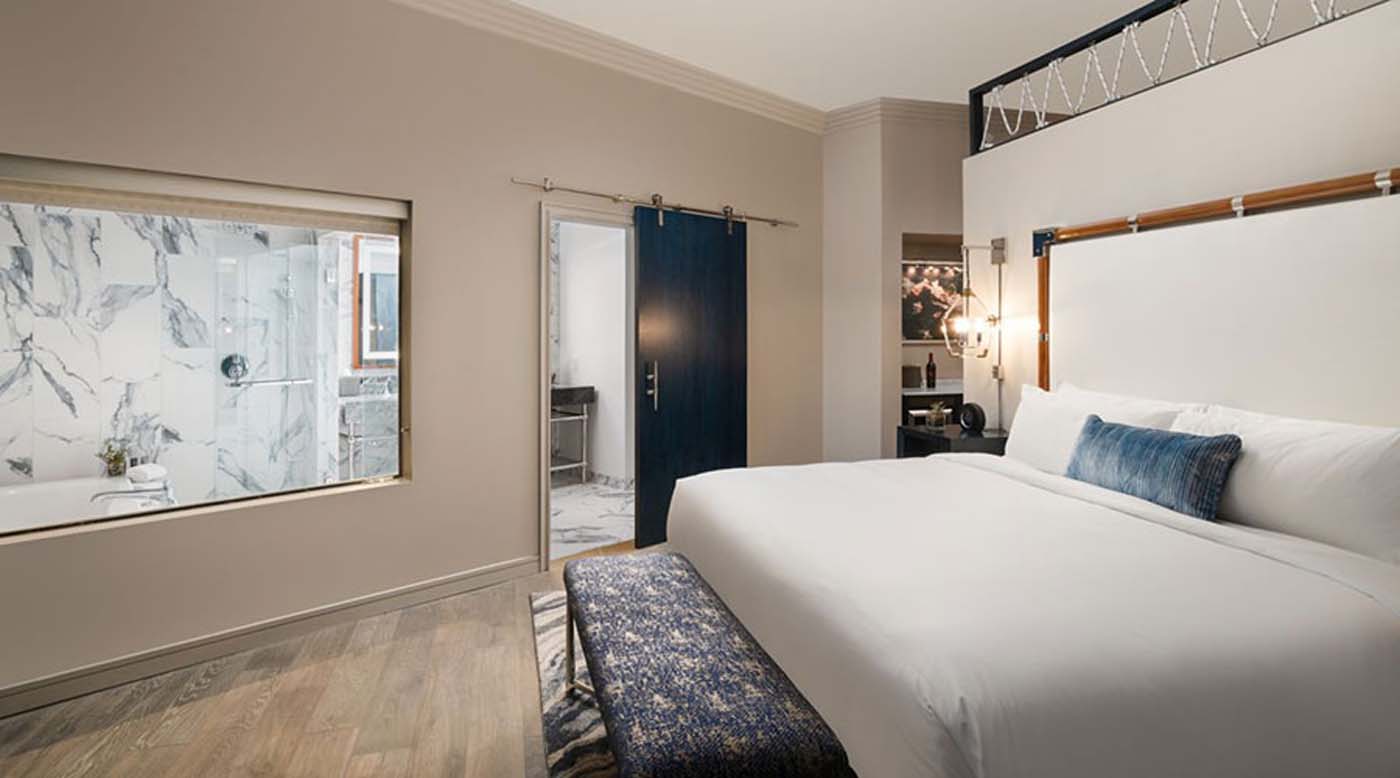 a bedroom with a bed and a bench