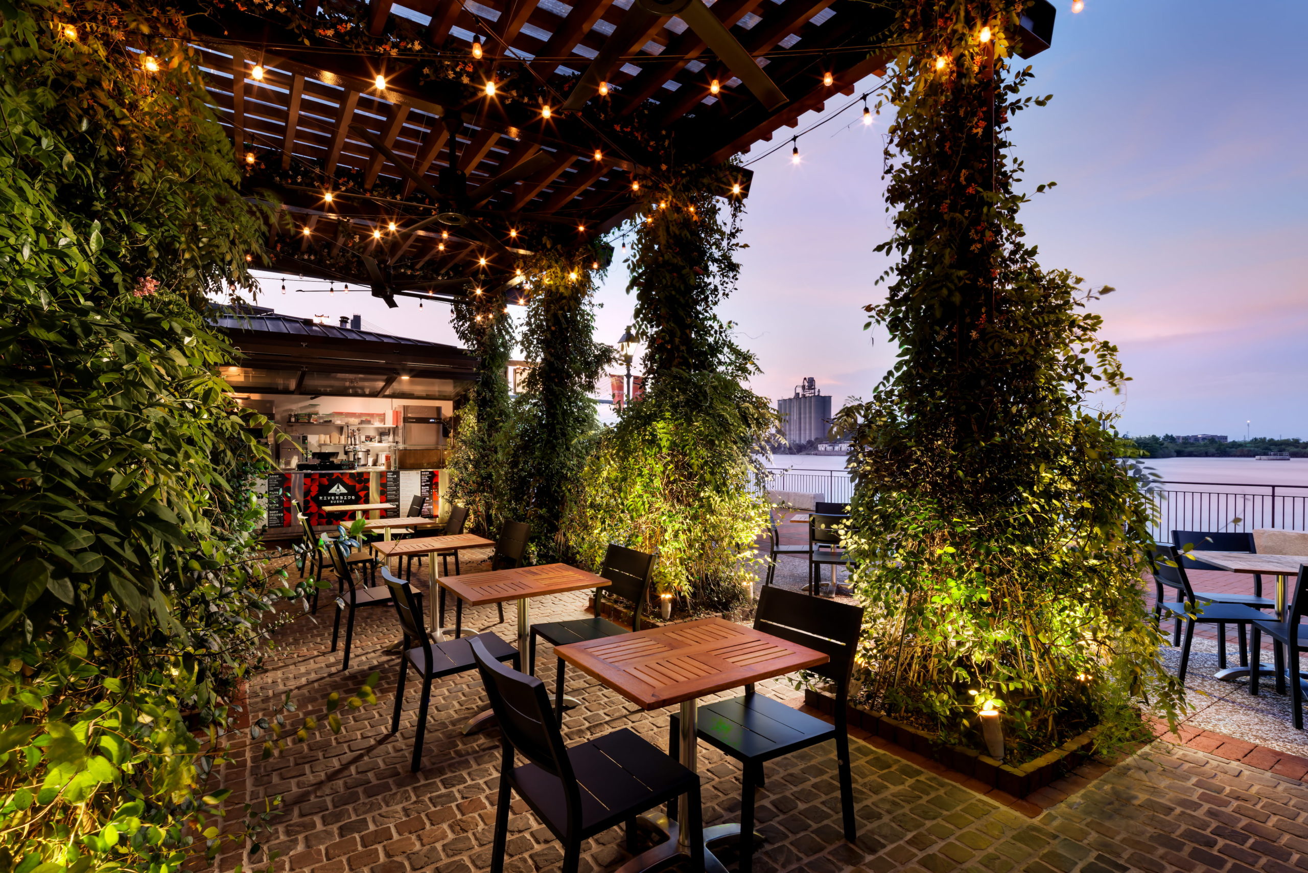 a patio with tables and chairs and lights
