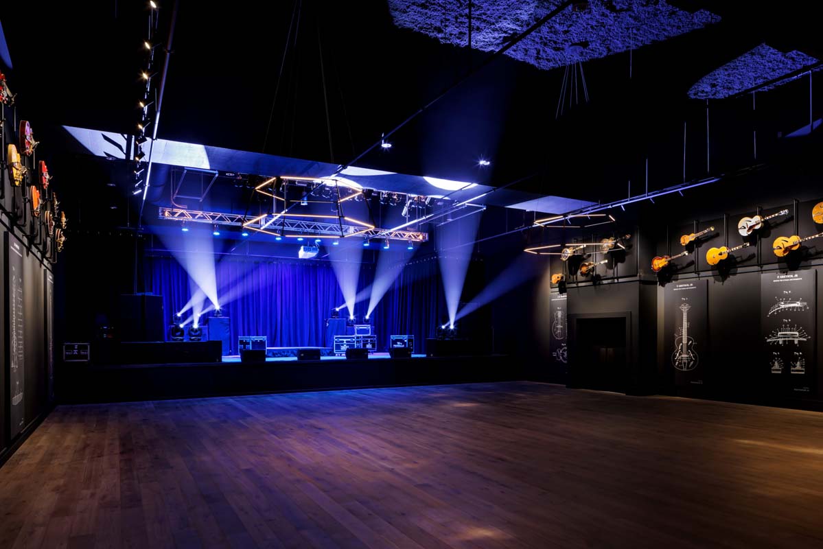 a stage with blue lights and a wood floor
