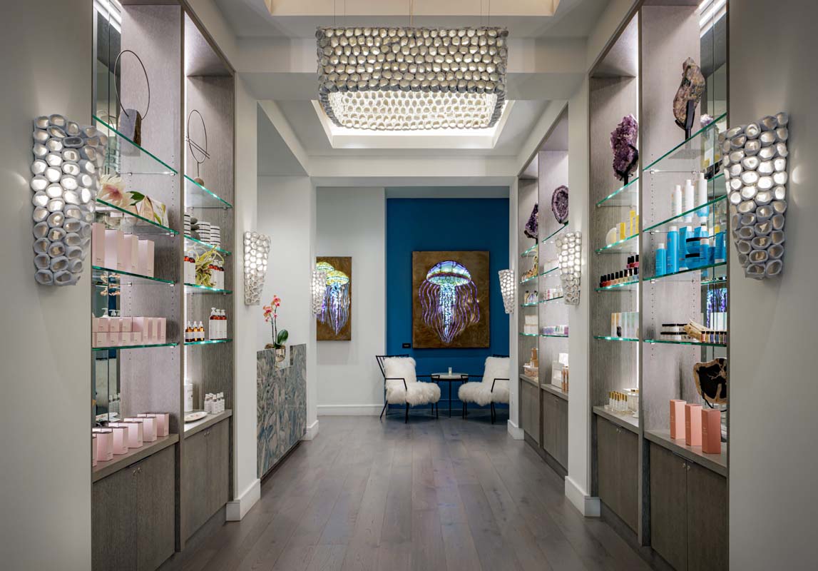 a room with shelves of cosmetics and a chair