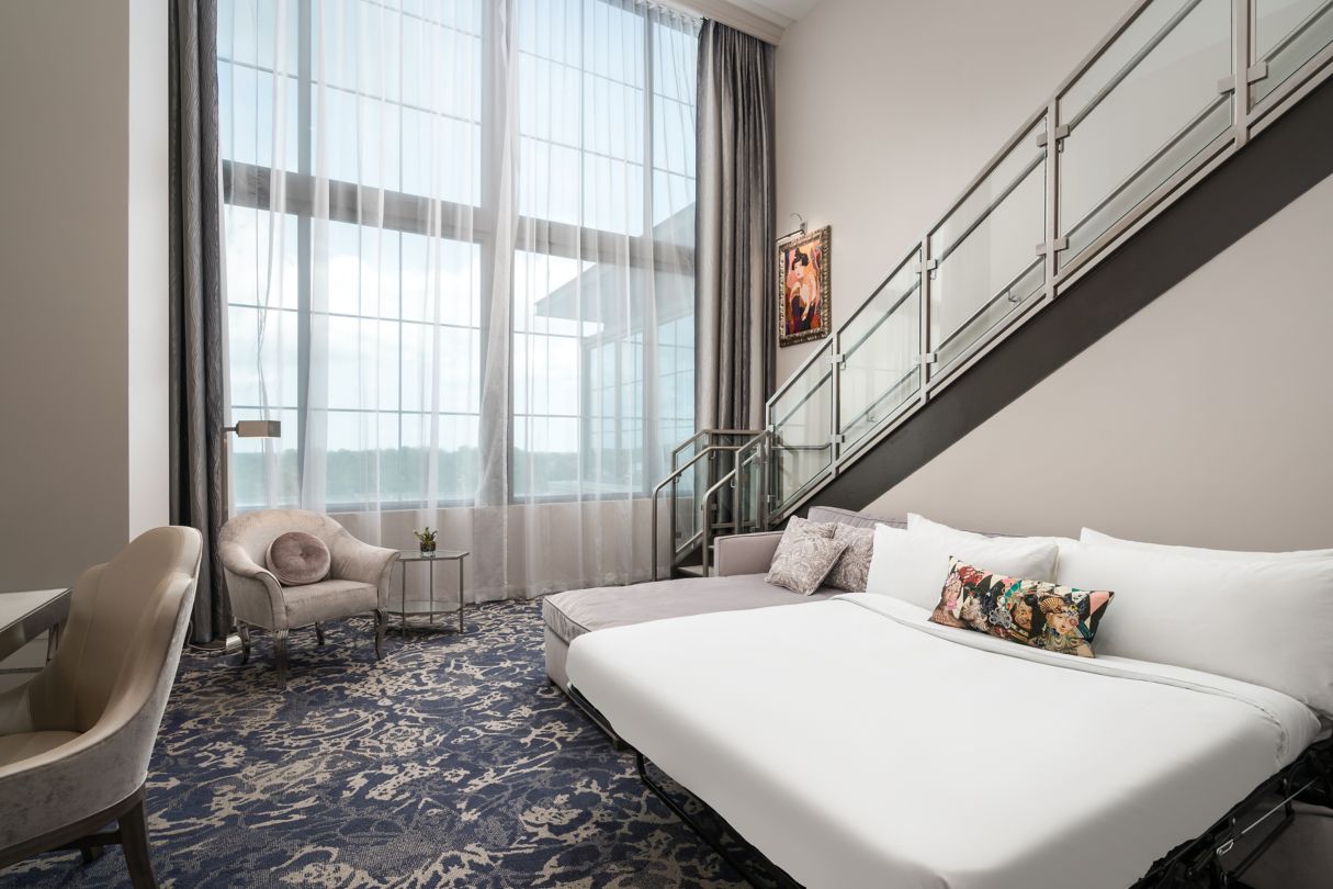 a bed in a room with a staircase
