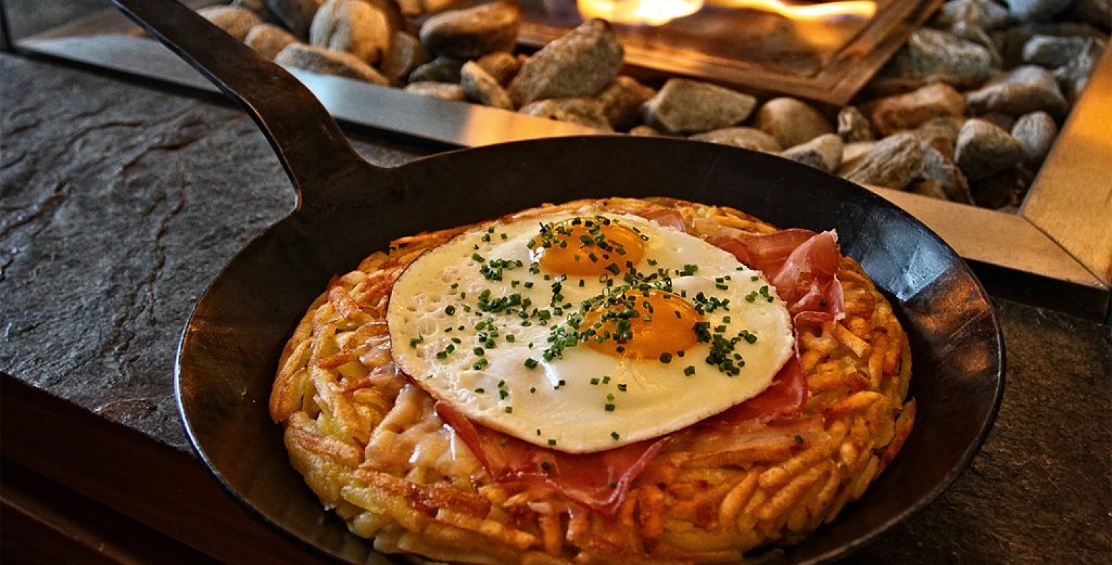 a pan with a fried egg and bacon