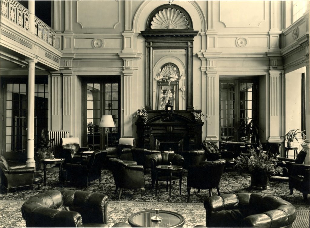 a room with a fireplace and chairs