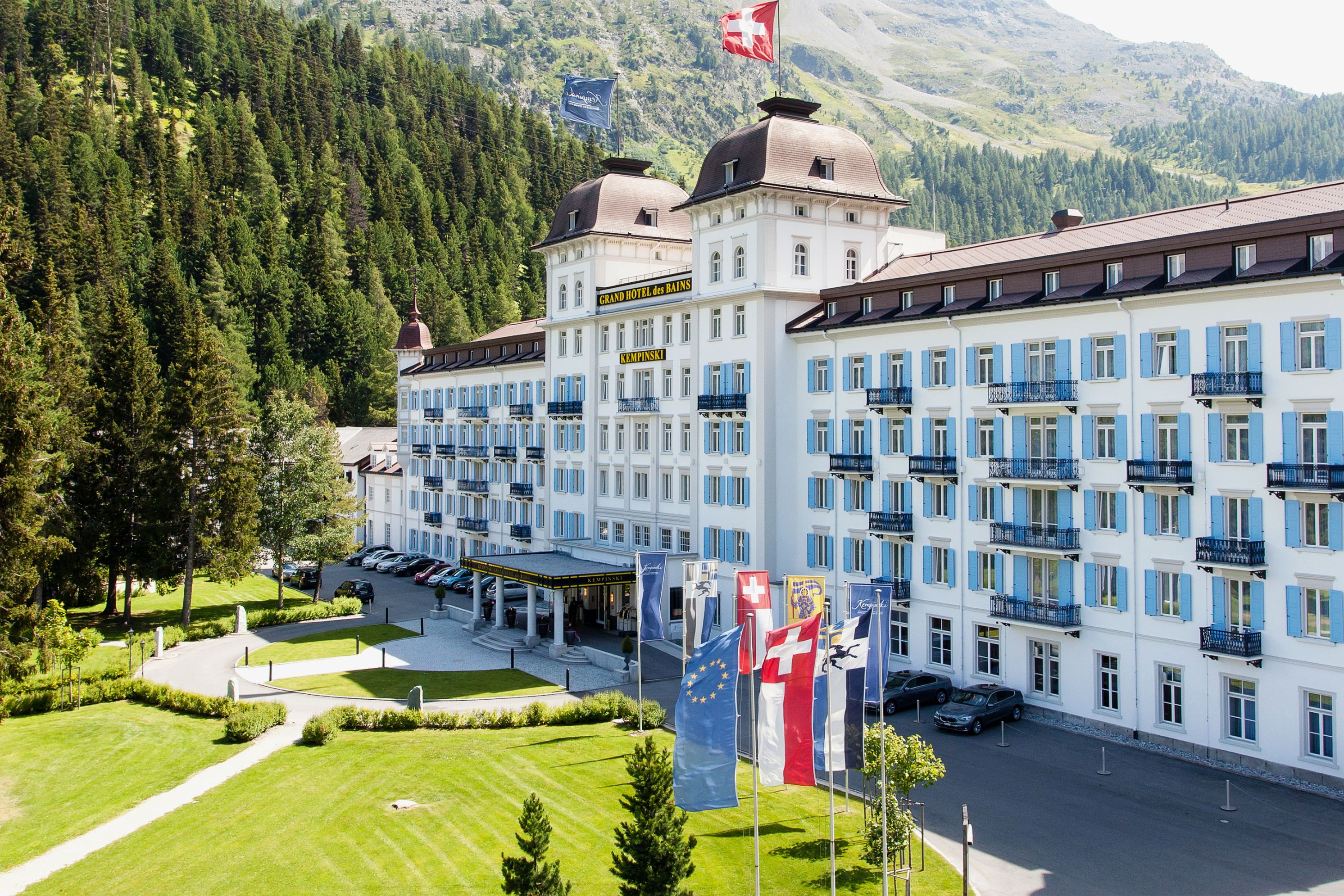 a large white building with flags on top of it
