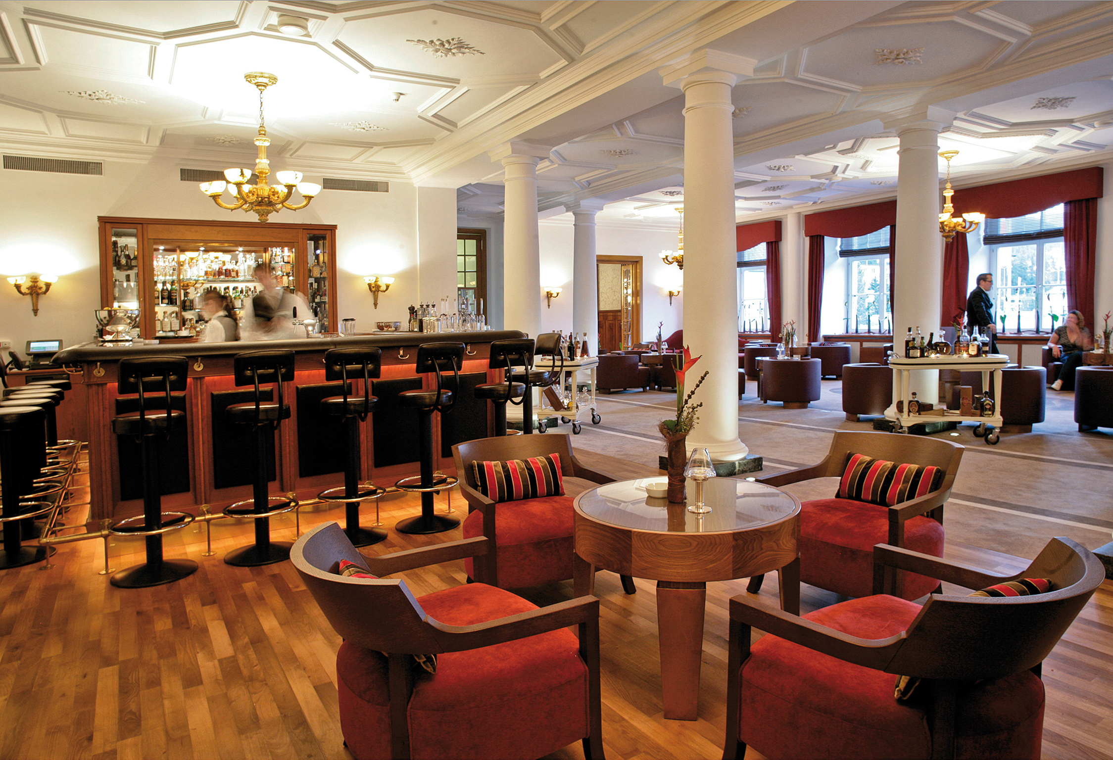 a room with a bar and chairs