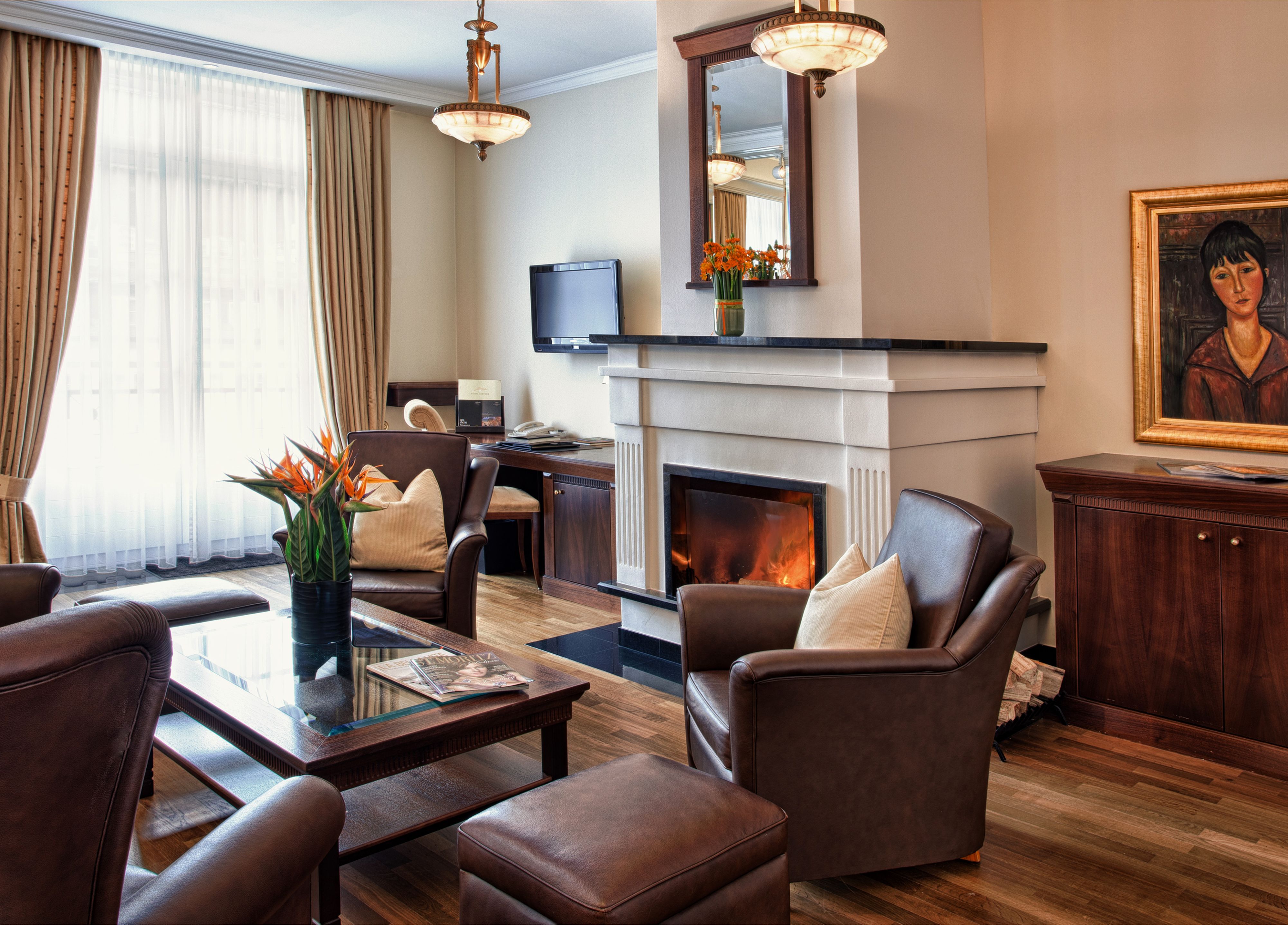 a living room with a fireplace and chairs