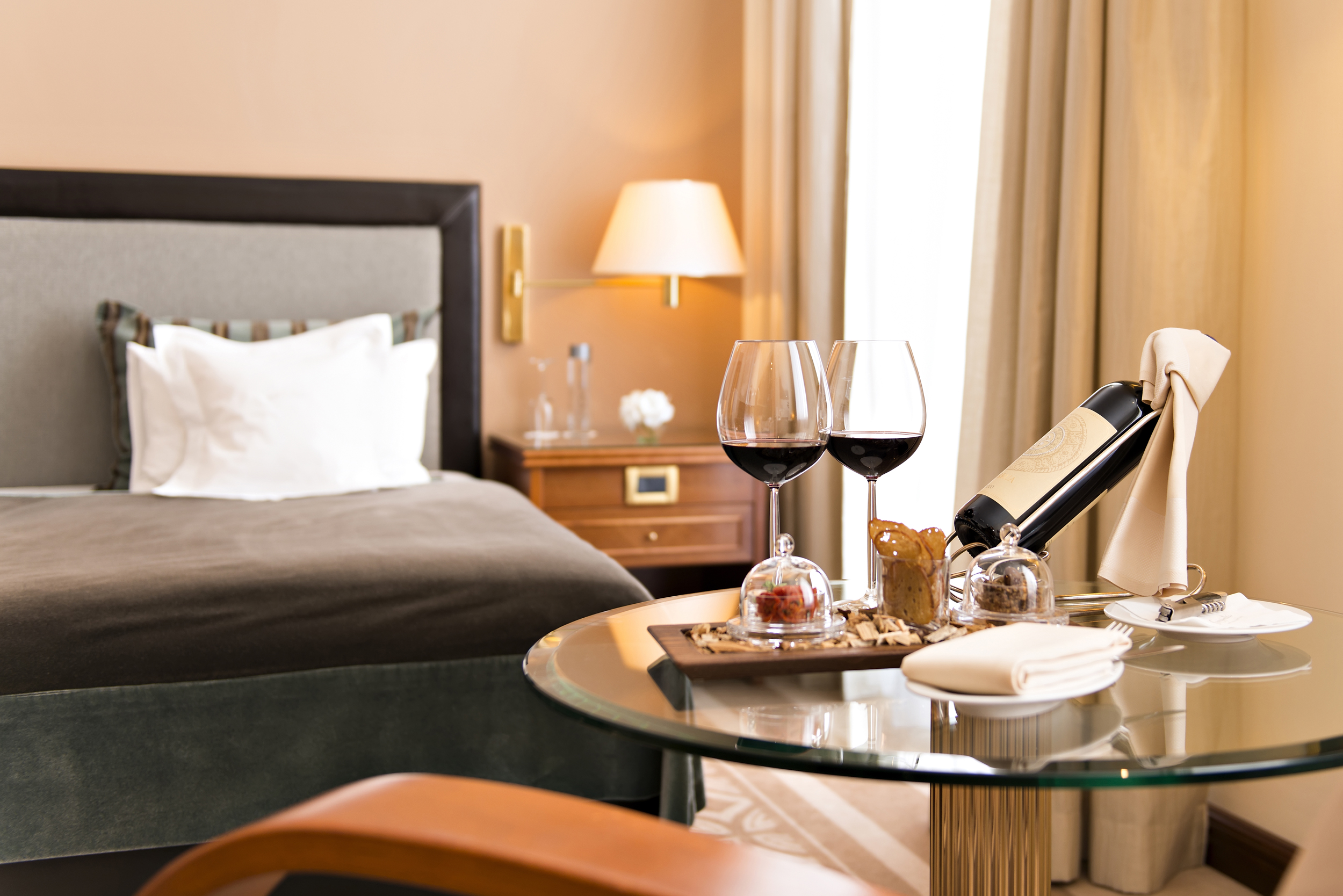 a glass table with wine and a bottle of wine on it