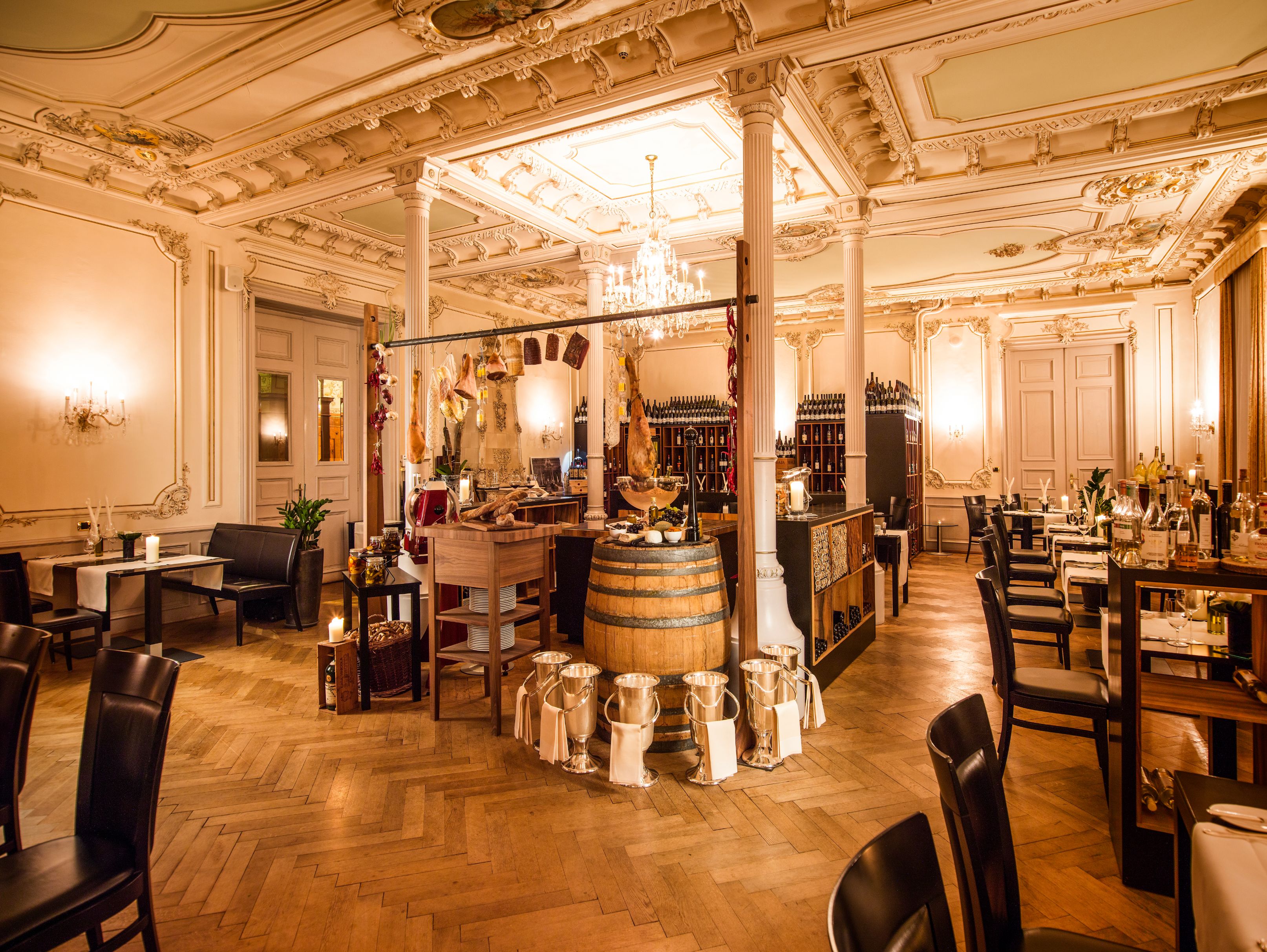a room with a wooden barrel and chairs