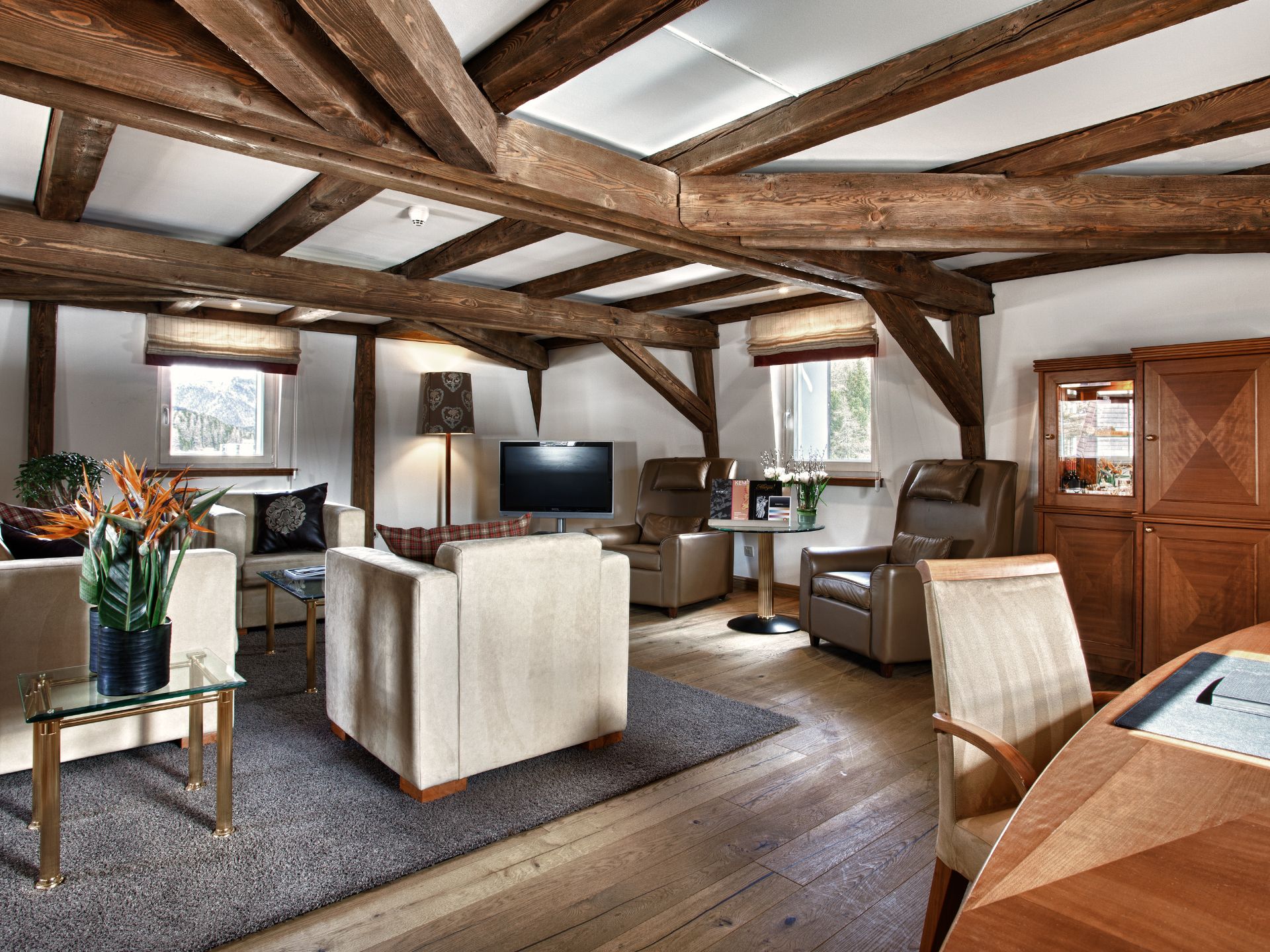 a room with wood beams and furniture