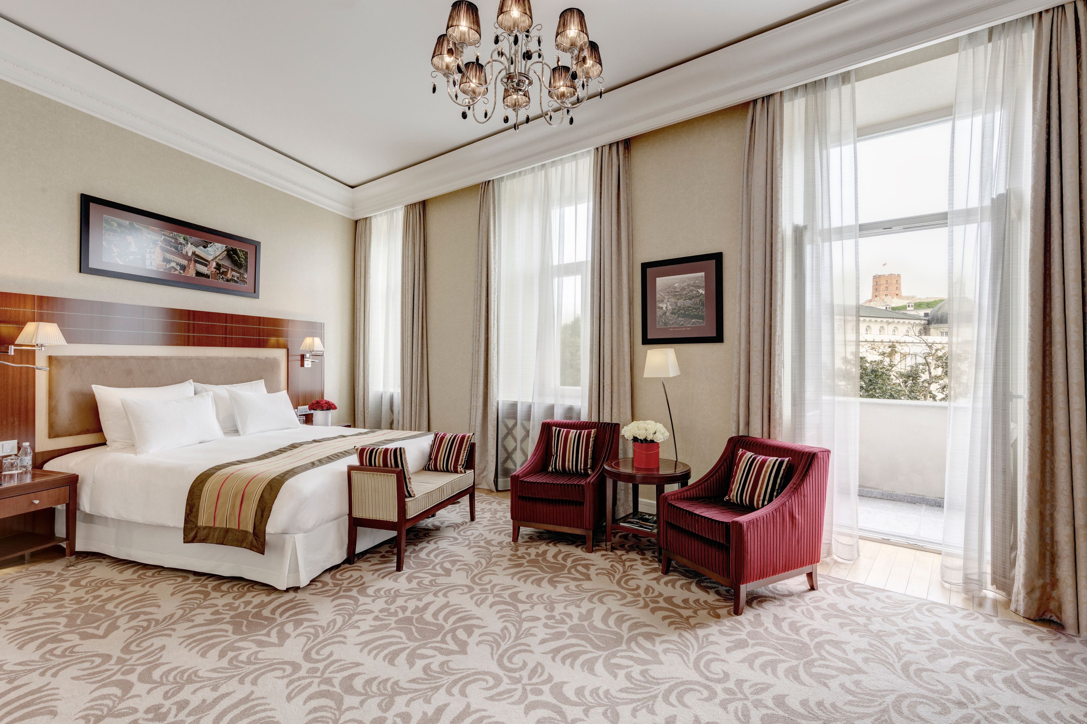 a bedroom with a bed and chairs