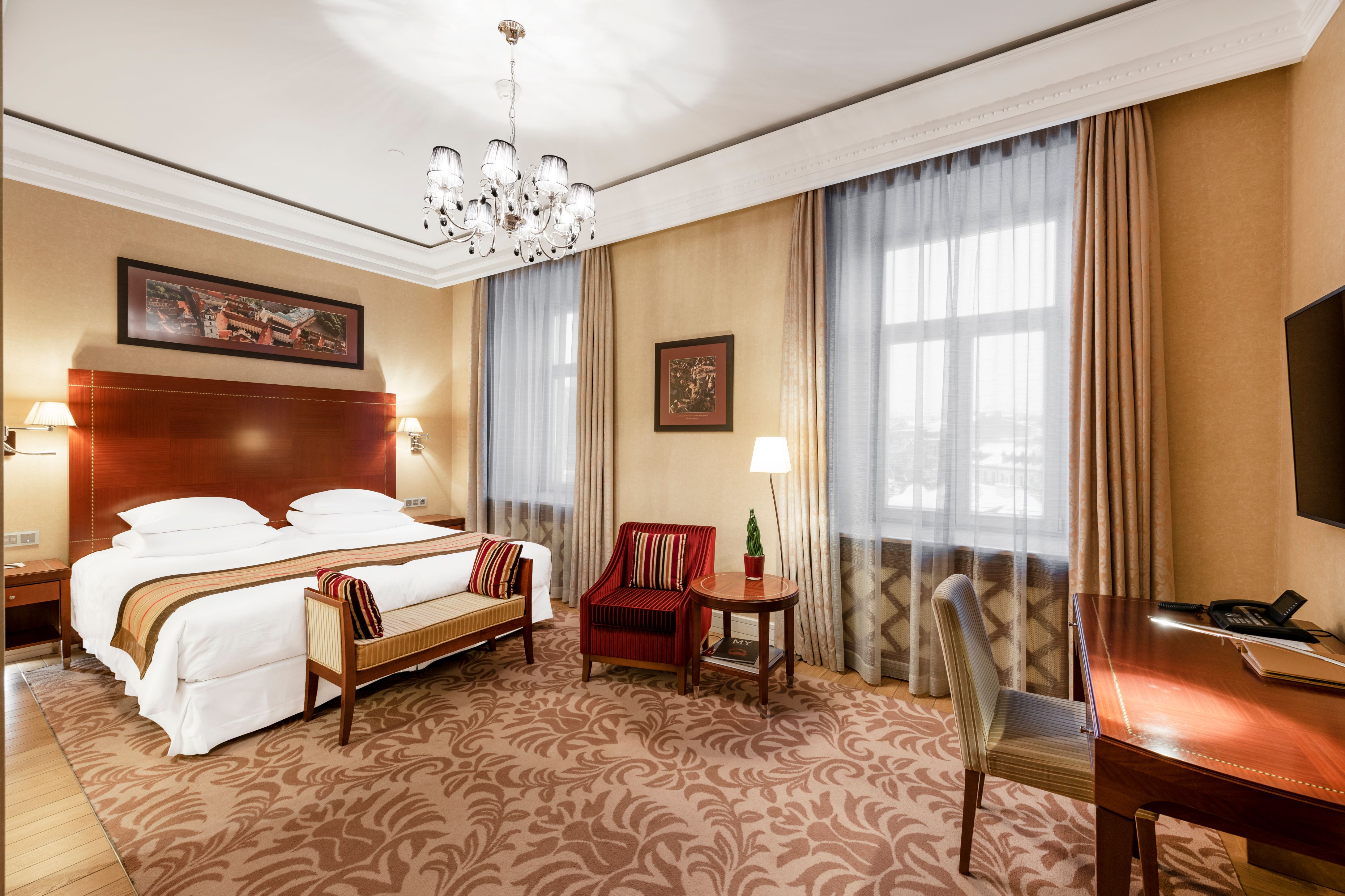 a room with a bed and chairs