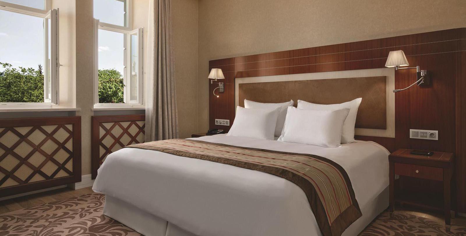 a bed with white pillows and a brown headboard