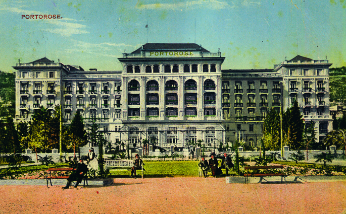 a large building with people sitting in front of it with Greystone Park Psychiatric Hospital in the background