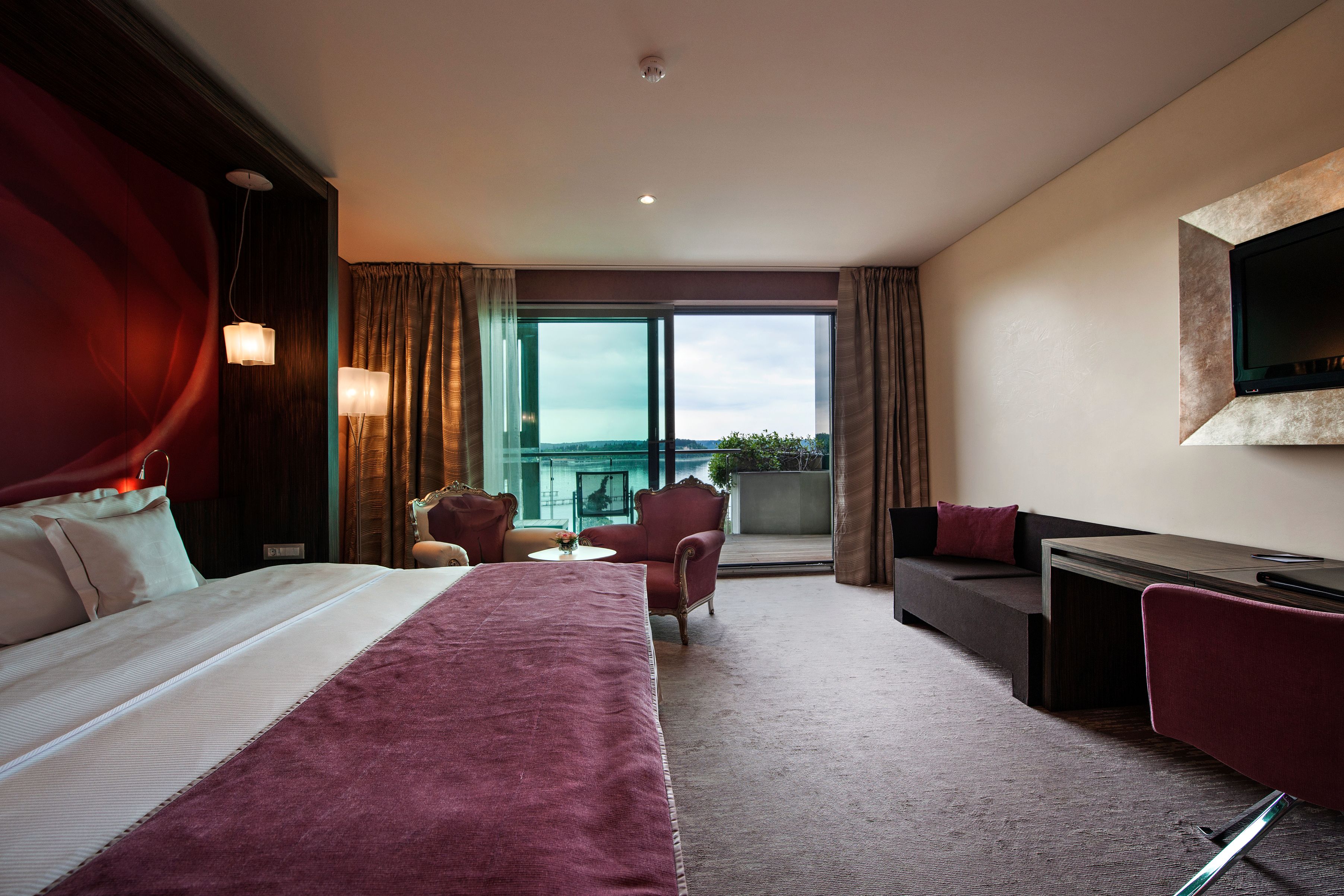a room with a bed and chairs and a couch