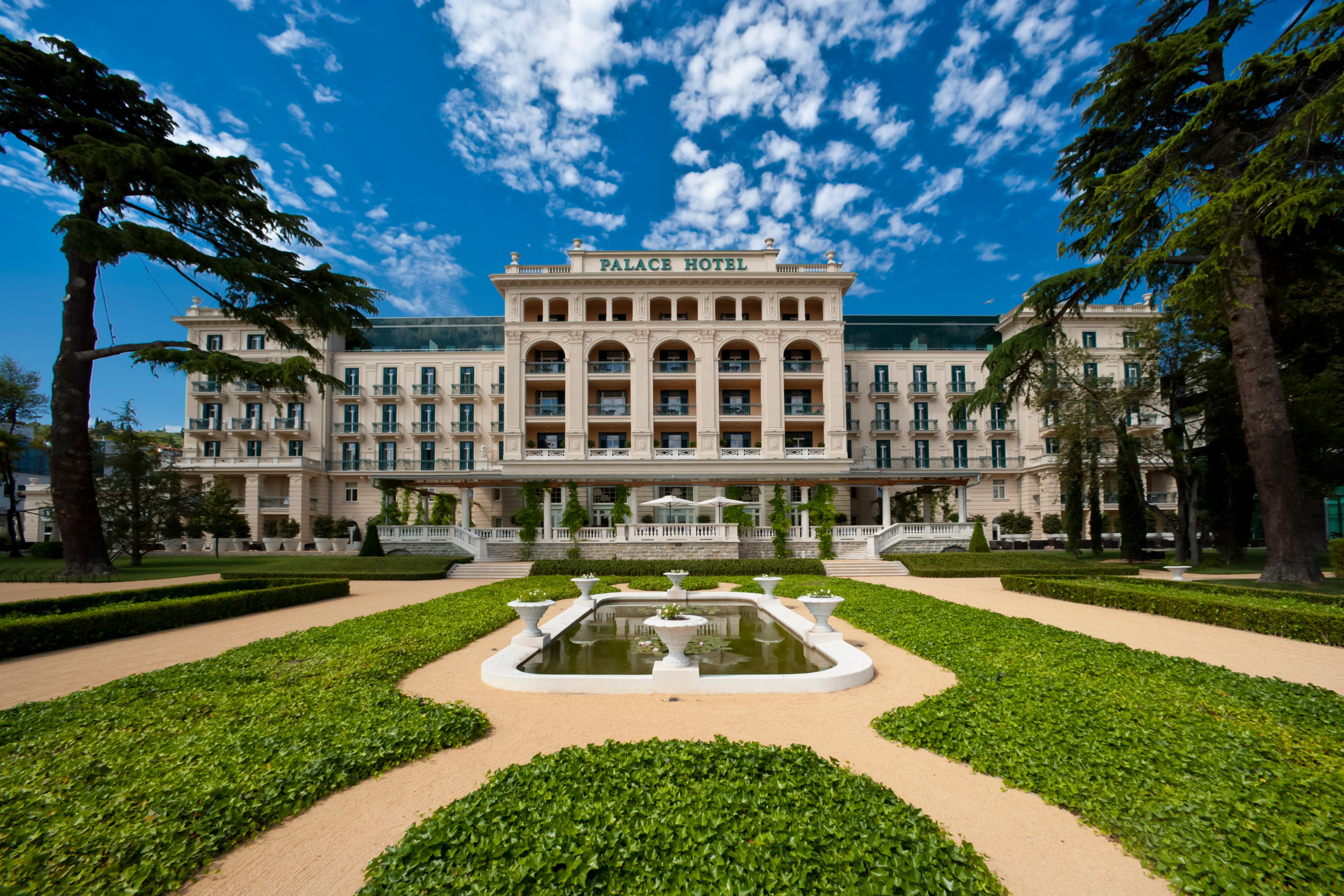 a large building with a fountain in front of it